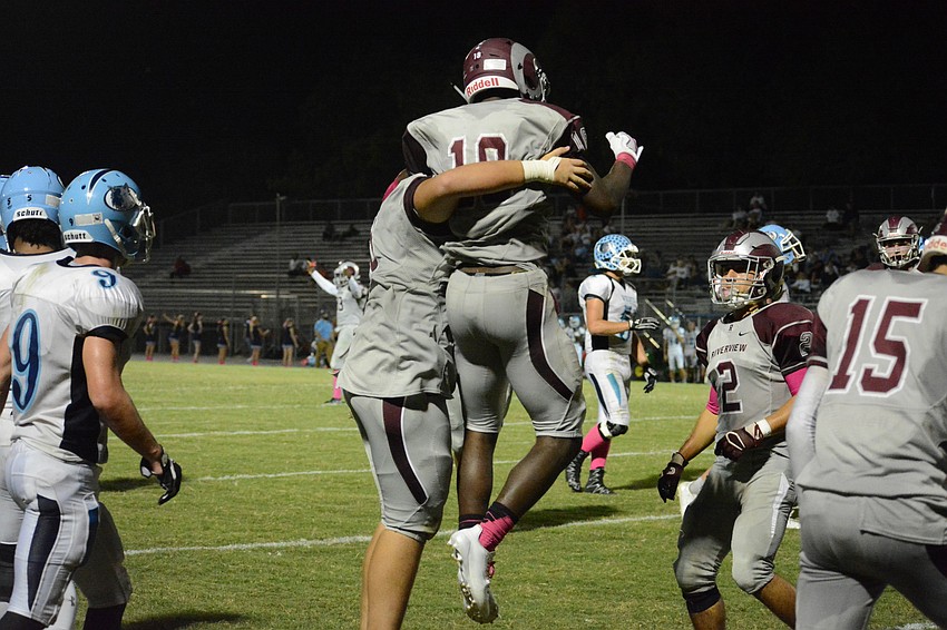 Junior offensive tackle Dominick Fitzgerald picks up Stephon Turner after Tuner's diving touchdown.