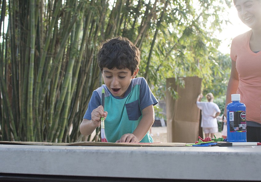David Harandi paints his brothers cardboard during the Global Cardboard Challenge at ODA.