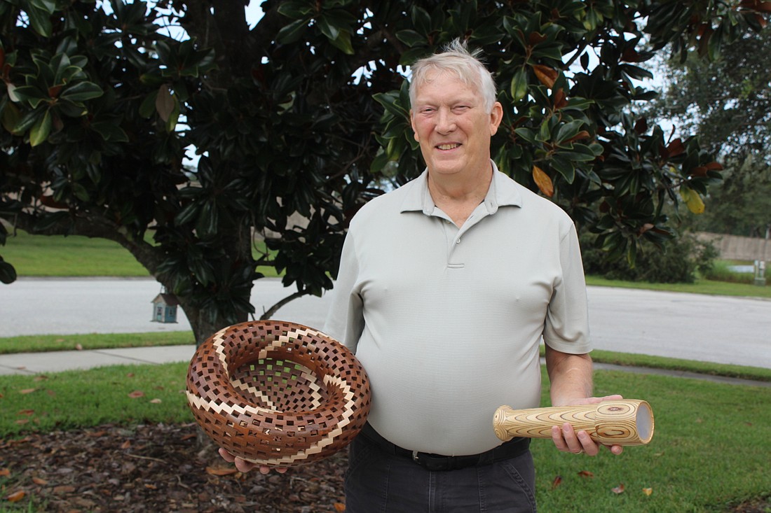 Mill Creekâ€™s Denny Wetter holds two of his prized creations, a segmented bowl and a kaleidoscope.