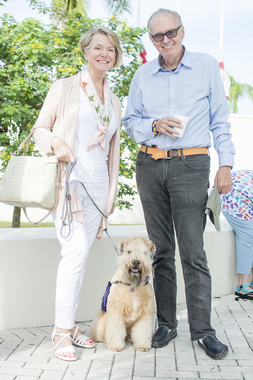 Bonnie Harrison and Tom Managhan pose with Harrison's husbands service dog Wyn.