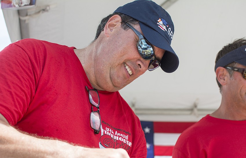 Michael Rodrigue of Sarasota Fire Department Station 16 pours chili samples at Morton's 18th Annual Firehouse Chili Cook-off.