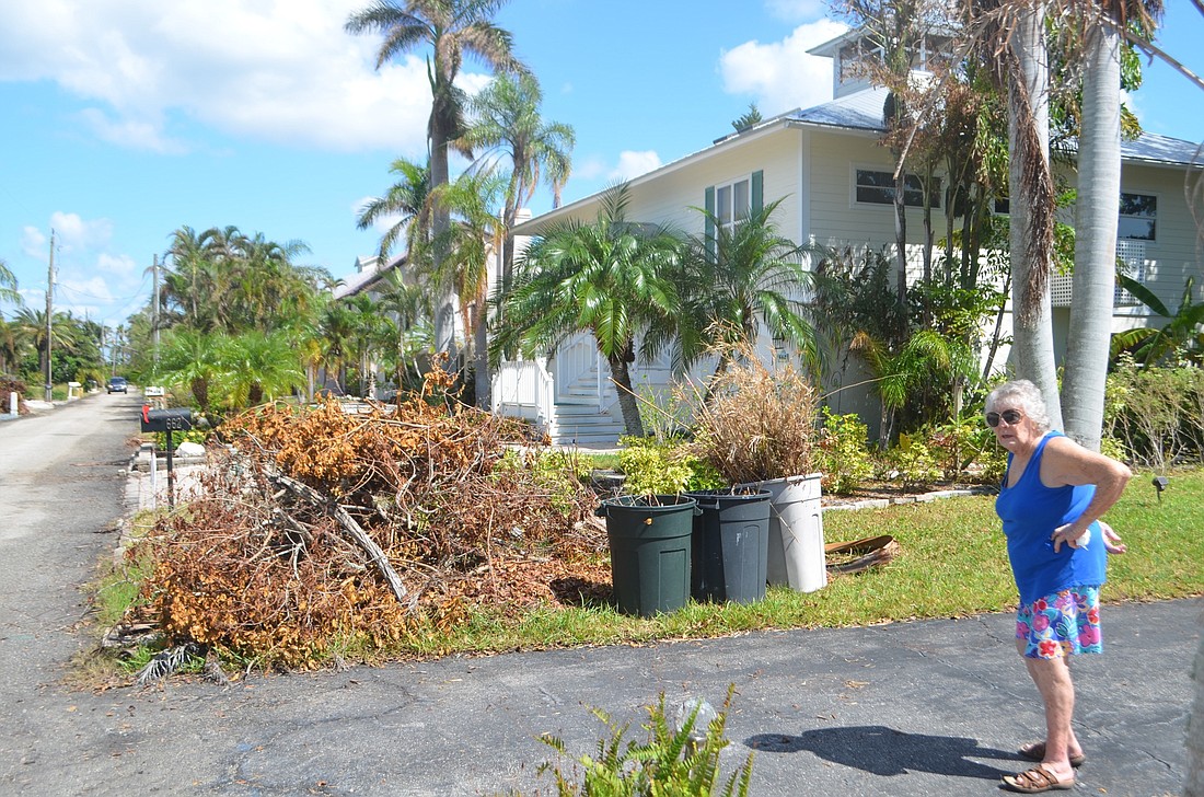 Arden Kreisch is among a dwindling number of Longboat residents with debris still piled in her yard.
