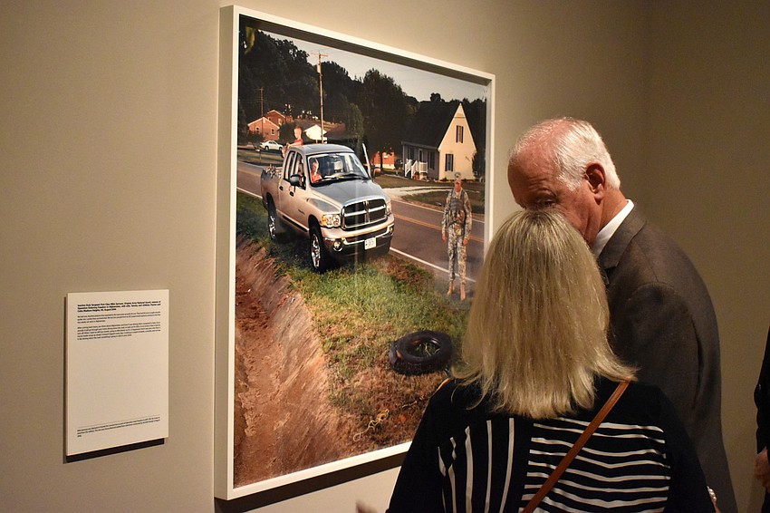 Hudson and Anne Smith discuss one of the photos on display by photographer Jennifer Karady