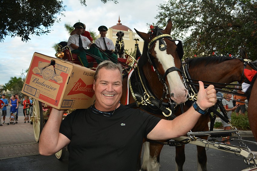 Gold Coast Eagle Distributing and the Clydesdales delivered a free case of Budweiser to Main Street merchant Tommy Klauber of Polo Grill & Bar.