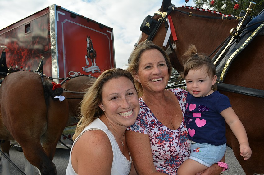 Mom Breanne Panetta of Palmetto , grandma Jackie Guy of Lakewood Ranch and daughter Taytum check out the Clydesdales because 