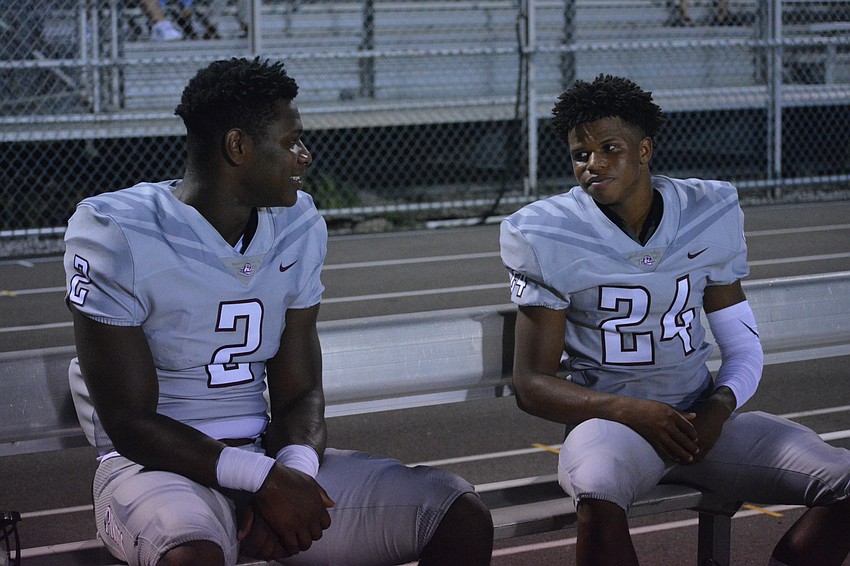 Braden River running backs Deshaun Fenwick and Camaron White chat with each other pregame.