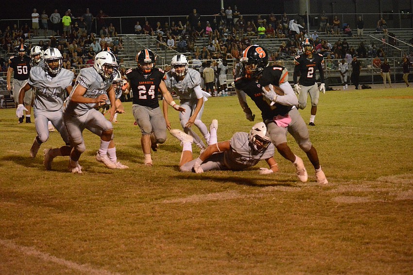Sarasota junior wideout Charles Ward takes a screen pass and cuts through the Pirate defense.