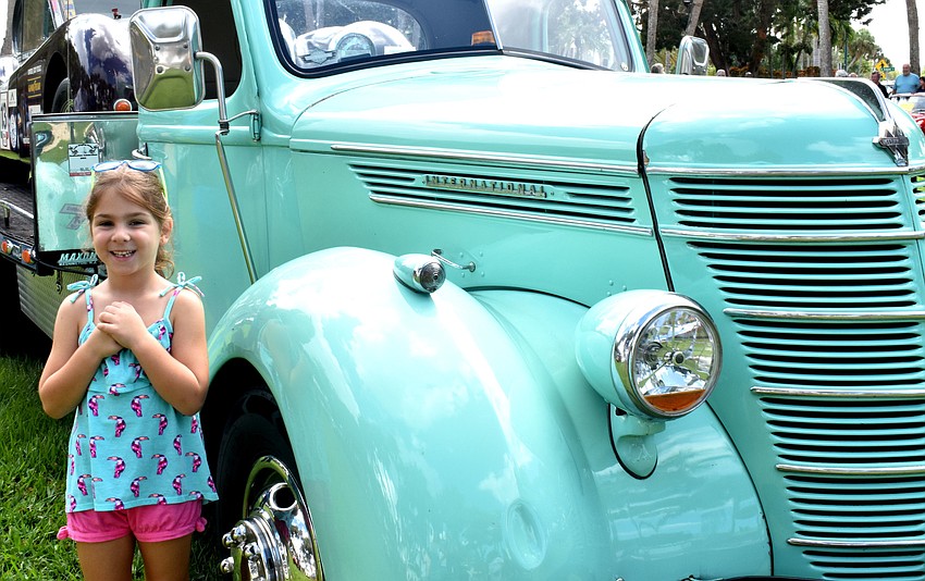 Myle Lorusso stands next to one of the Jaguar automobiles on display during the Sun Coast Jaguar Club 32nd Annual Concours d’Elegance.