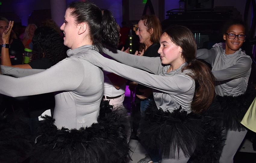 Performers start a conga line on the dance floor at the Amazing Raise — Raise the Roof Party on Oct. 14 at Michael’s On East.