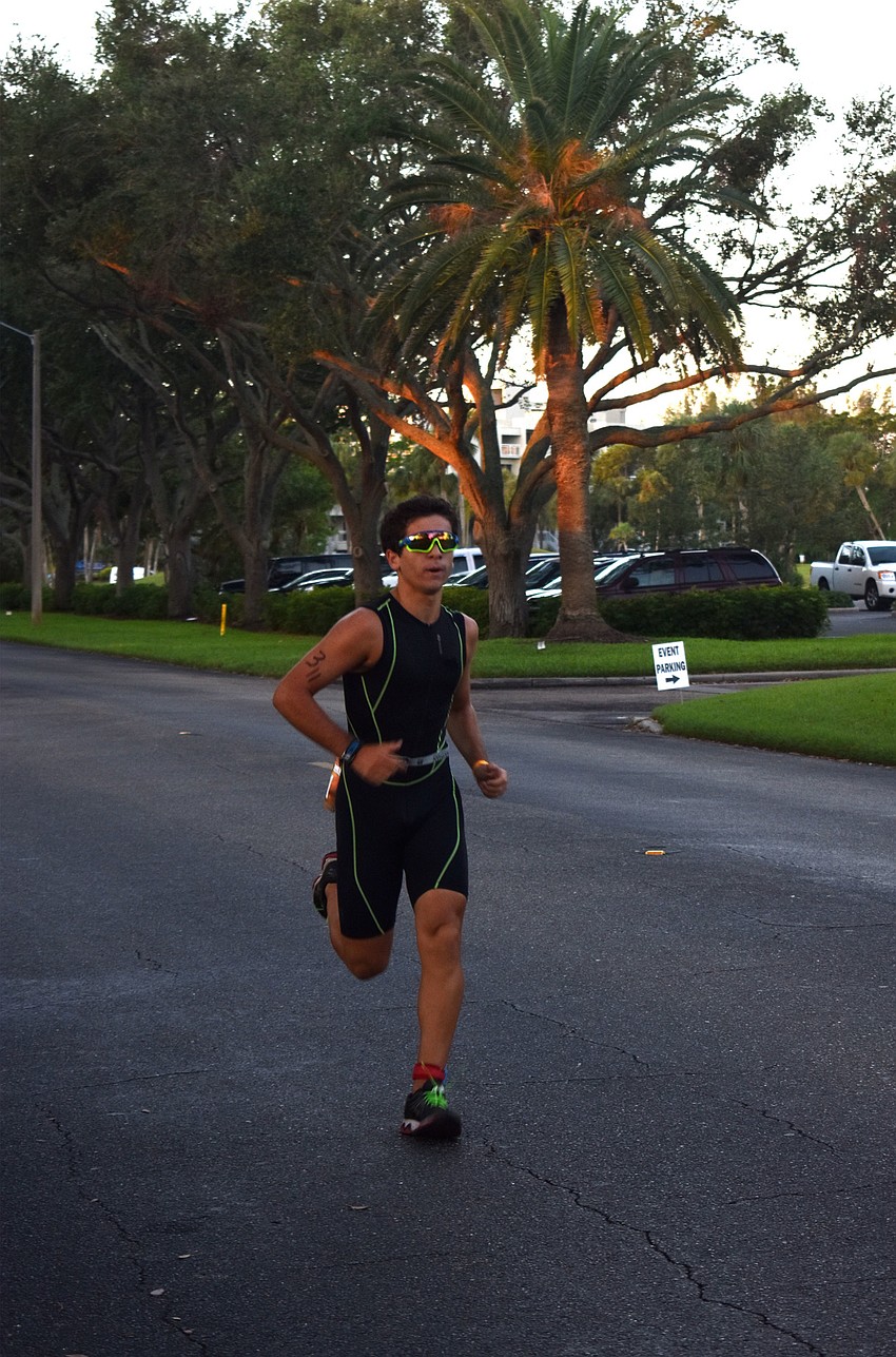 Tj Freer runs down Longboat Club Road during the Longboat Key Triathlon.
