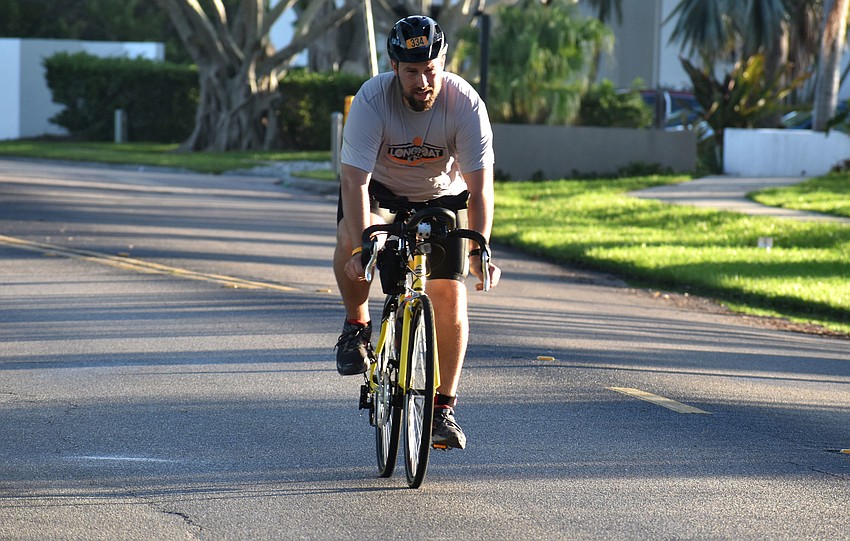 Ronald Reader gets ready to dismount his bike and begin the second running portion of the duathlon.