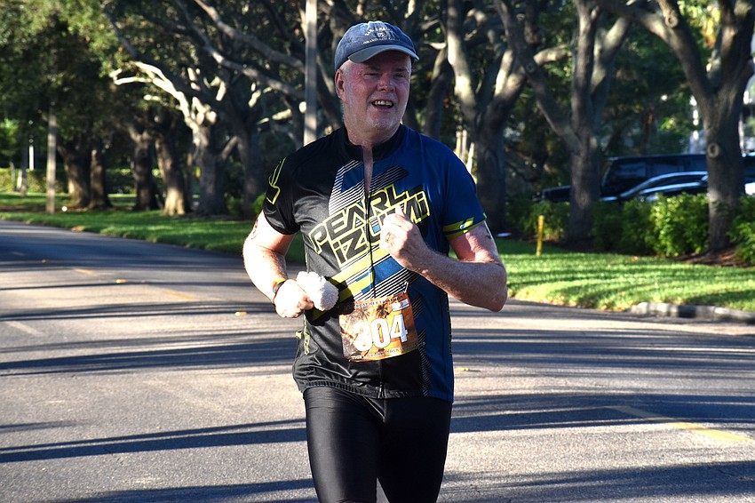 Paul Drummey runs down Longboat Club Road during the second running leg of the duathlon.