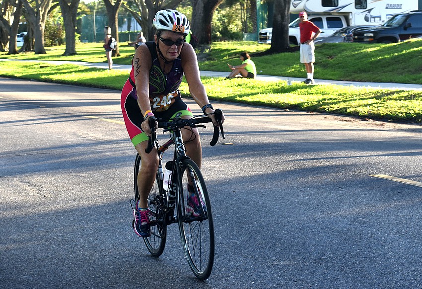 Kathy Bayles races down Longboat Club Road during the biking portion of the duathlon.