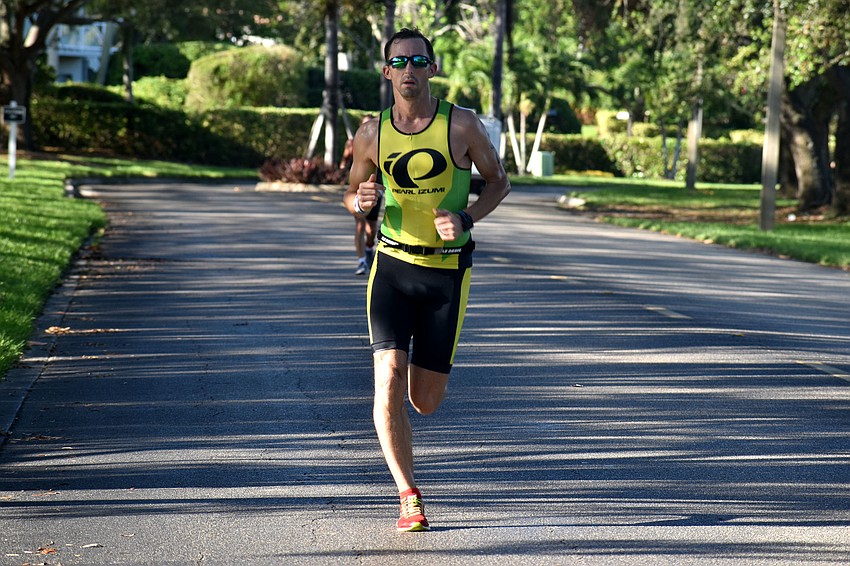 Benedict Riches races down Longboat Club Road during the second running leg of the international duathlon.