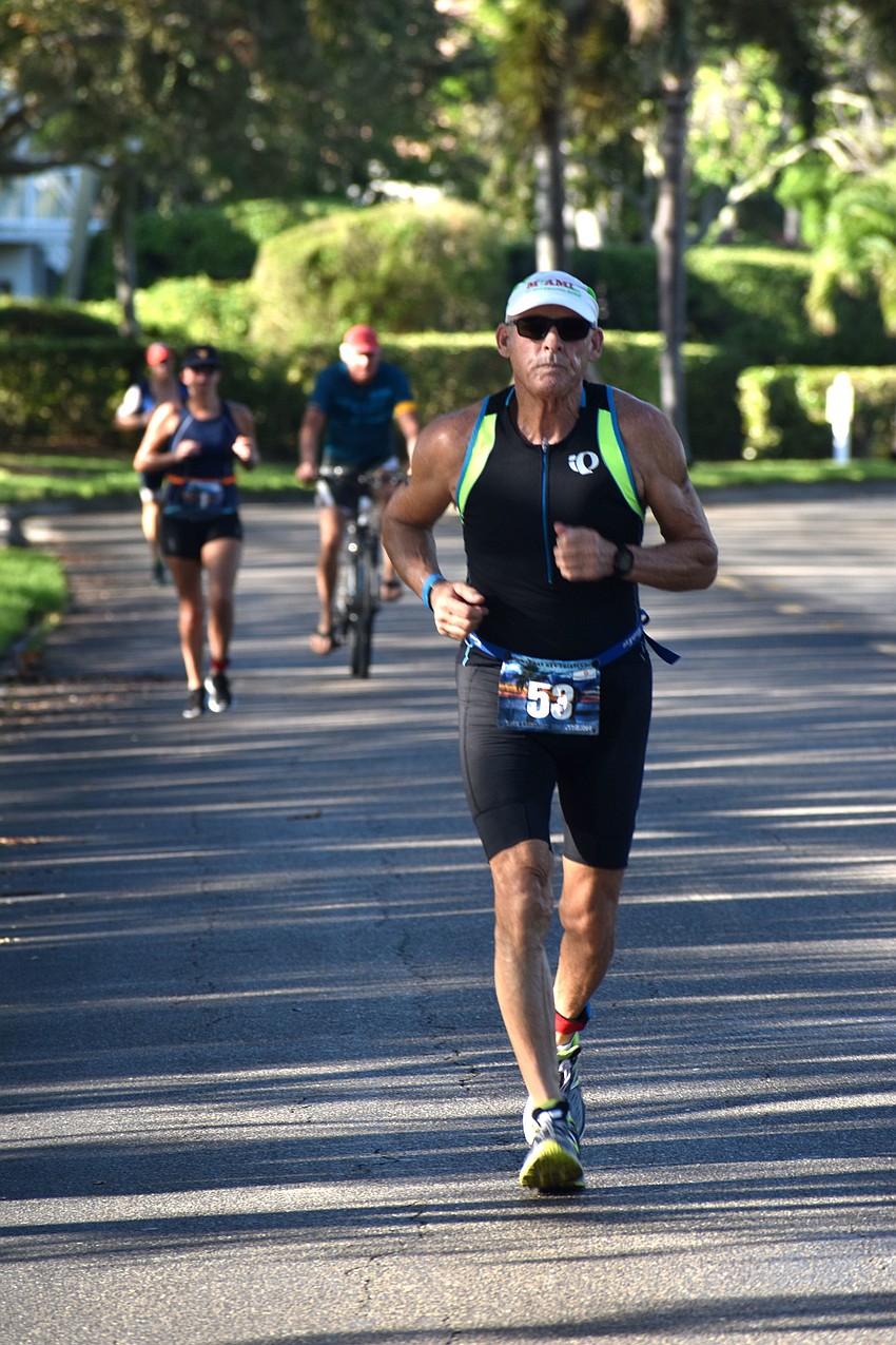 Carl Lovetere races down Longboat Club Road during the second running leg of the international duathlon.