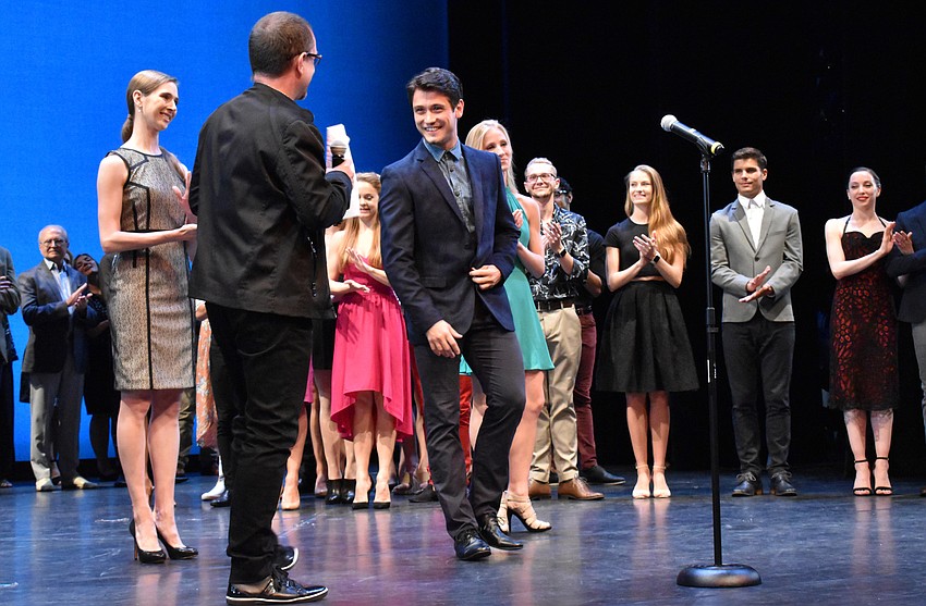 Director Iain Webb surprises dancer Lucas Erni by telling him he’s been promoted to junior principal.