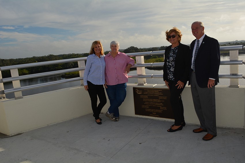 Manatee County Commissioners Carol Whitmore, Priscilla Whisenant Trace, Betsy Benac and Stephen Jonsson pose by a marker with their names on the bridge.