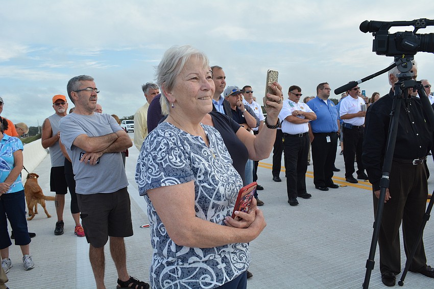 Joyce Colligan, of River Wilderness,  is all smiles as county officials open the Fort Hamer Bridge.