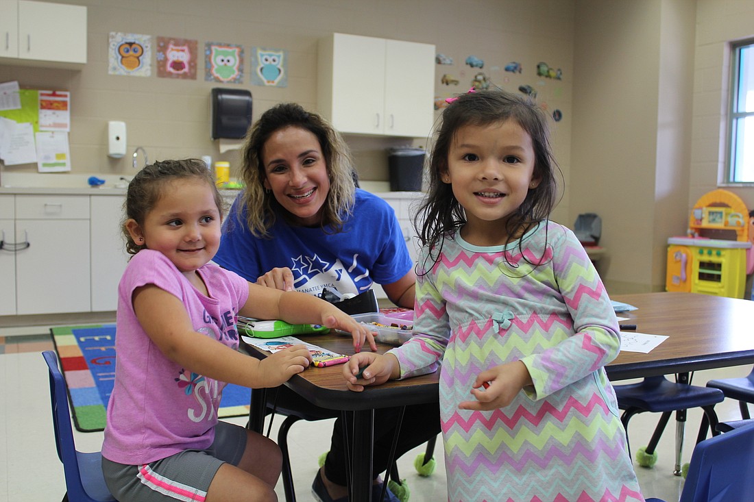 Natalia Besse, 3, Wandelisse Castillo and Ariella Castillo, 3, play games in the Kid Zone at the Lakewood Ranch YMCA.