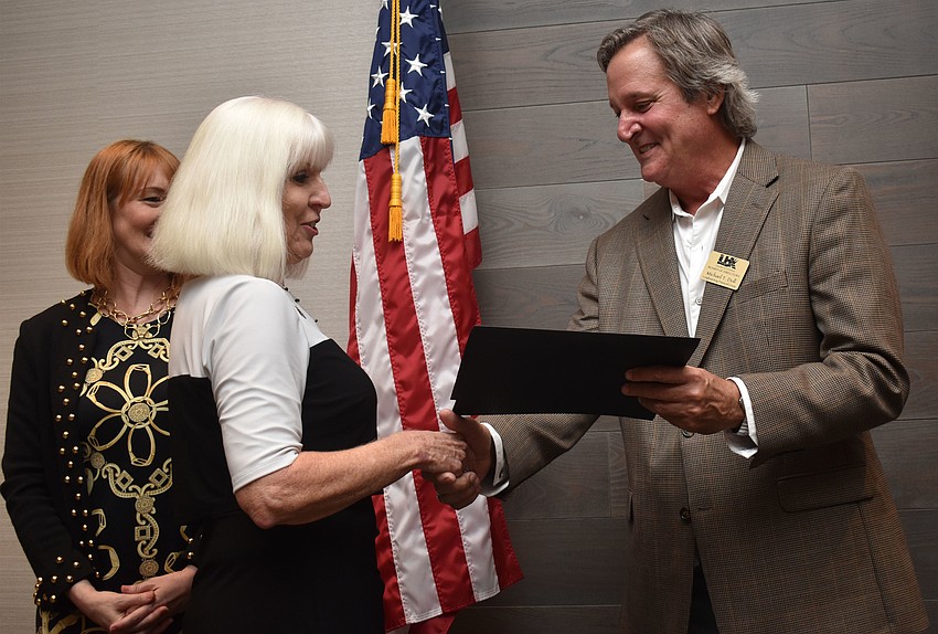 Chamber Chairman Michael Doll hands Debra Fortosis of Elite Family Care her second place award for Small Businessperson of the Year 10 or fewer employees.