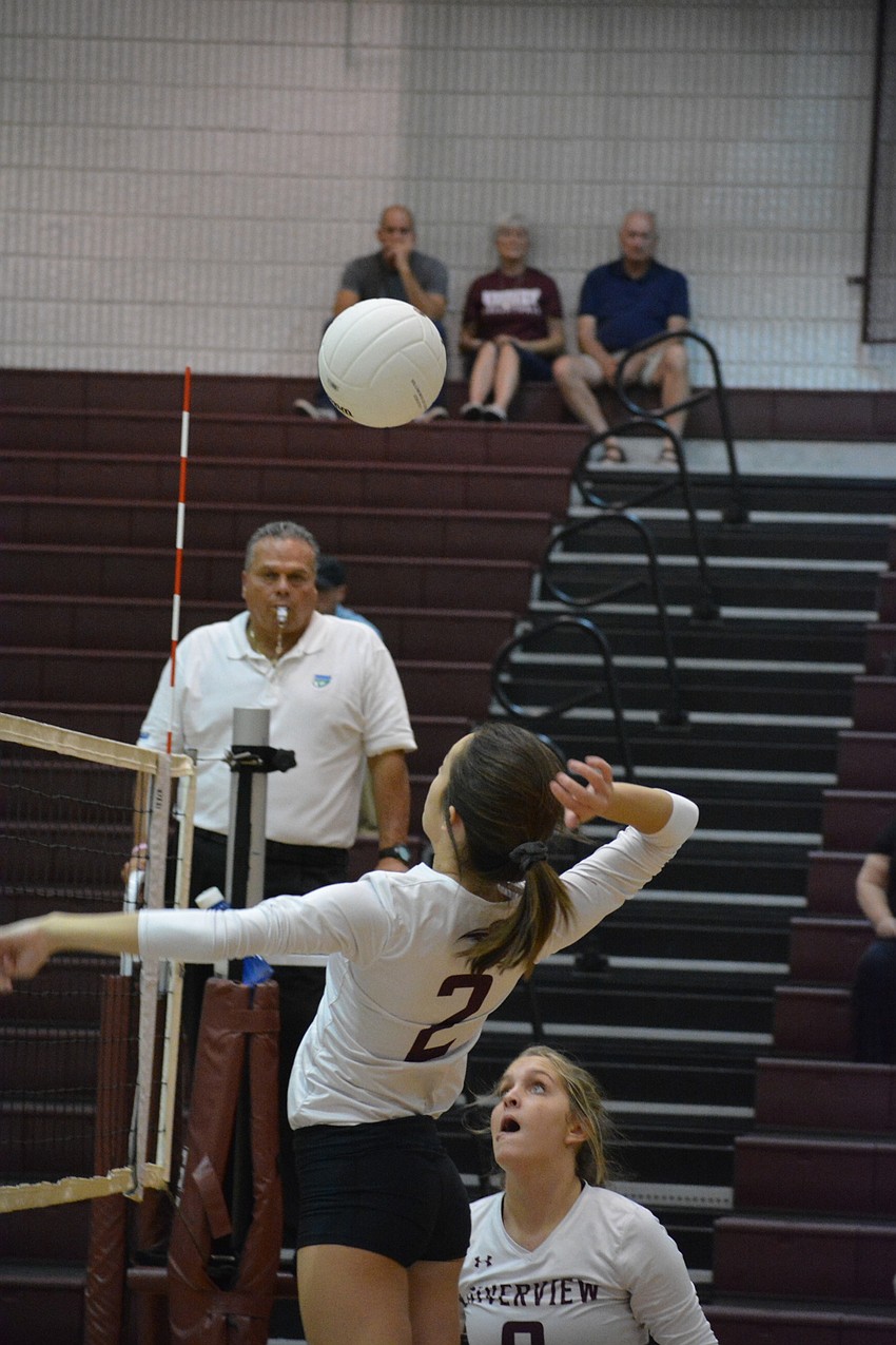 Reagan Douberly jumps to spike a ball during the first set.