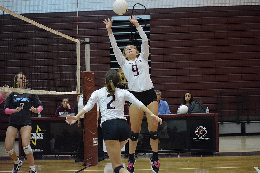 Kayla Walker (9) sets a ball for teammate Reagan Douberly. Walker had 30 assists on the night.