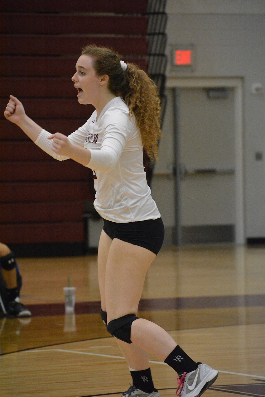 Jena Robustelli raises her hands after the Rams won a point on her serve.
