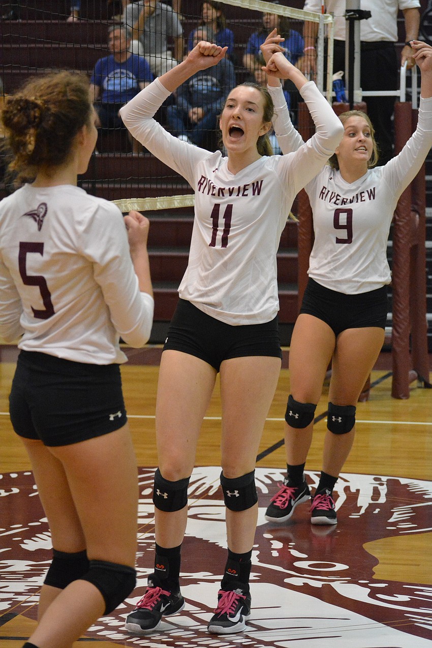 Riah Walker, Abby Quigley and Kayla Walker celebrate a big point.