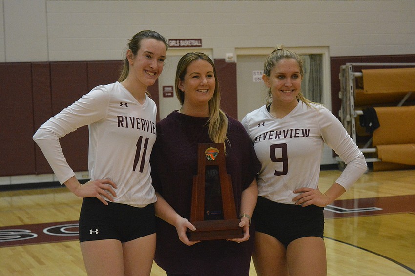 Abby Quigley, Nickie Halbert and Kayla Walker pose with the trophy.