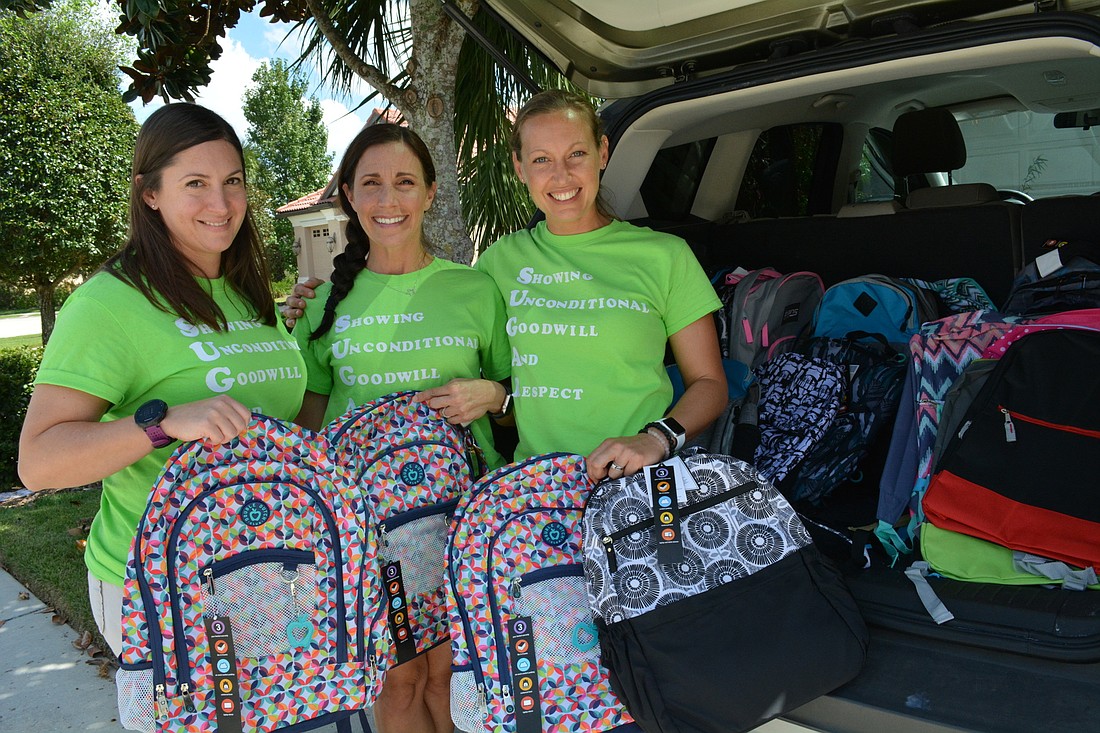 SUGAR founders Victoria Cobb, Stefanie Guido and Ali Pereira  show off new backpacks donated after they posted a request on Facebook.