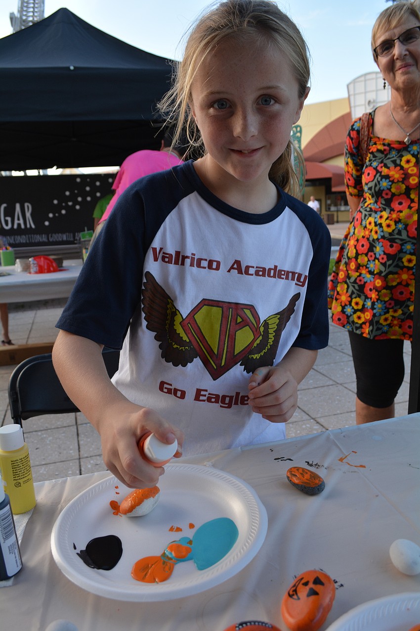 Lauren William, of Valrico, paints a rock at the LWR Kindness Project Club Day booth she visited with her grandma, Judy Williams, of Lakewood Ranch.
