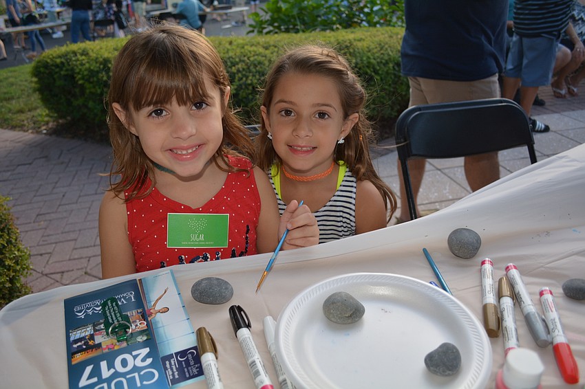 Phoebe and Abigail Cobb decorate rocks as the LWR Kindness Project booth at Club Day.