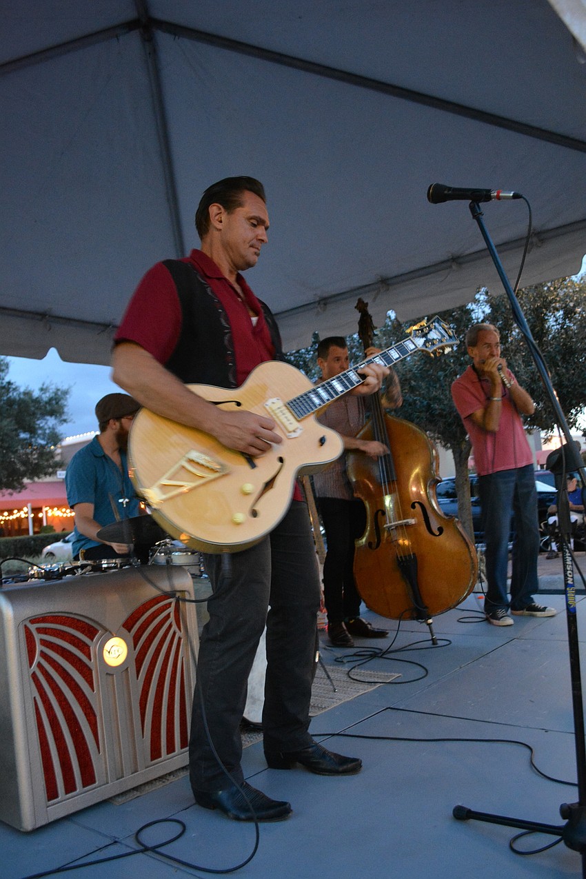 Doug Deming, of Doug Deming & the Jewel Tones, livens the street with good music.