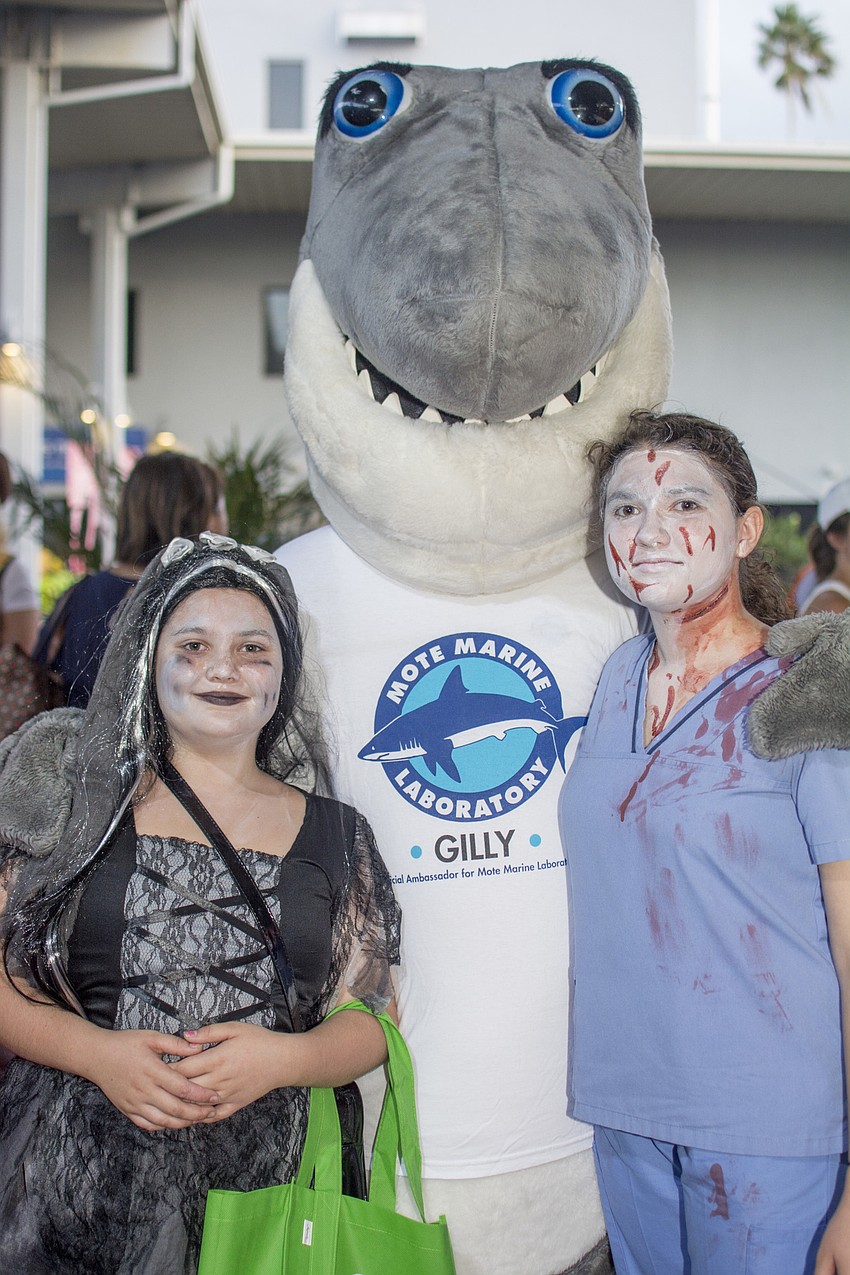 Emily and Kaitlyn Shehorn pose with Gilly during Mote's Night of Fish, Fun and Fright.