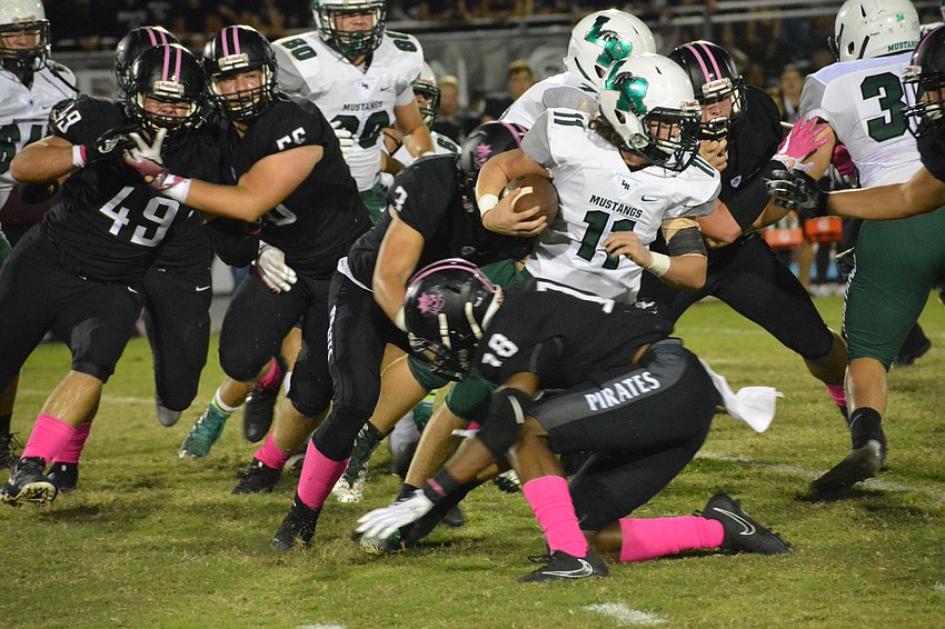 Mason Fischer runs between the tackles for positive yardage.