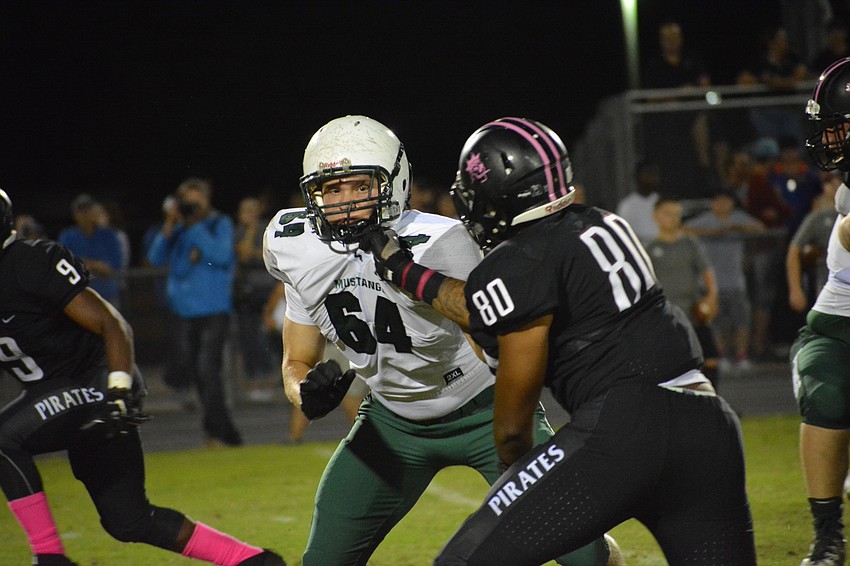 Lakewood Ranch offensive lineman John Riley takes a hand to the face while blocking University of Florida verbal commit Taylor Upshaw.