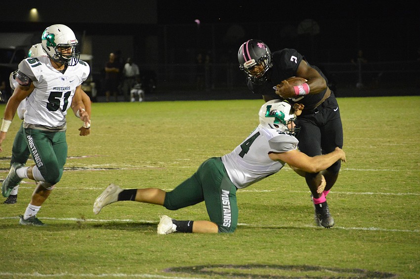 Lakewood Ranch linebacker Chase Sharp takes down Braden River's DeShaun Fenwick by the legs. Fenwick, a University of South Carolina verbal commit, had just five carries on the night.