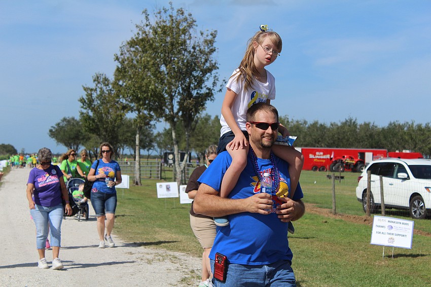 Homosassa's Chloe and John Zuidema stroll through Hunsader Farms during  the 15th annual Buddy Walk.
