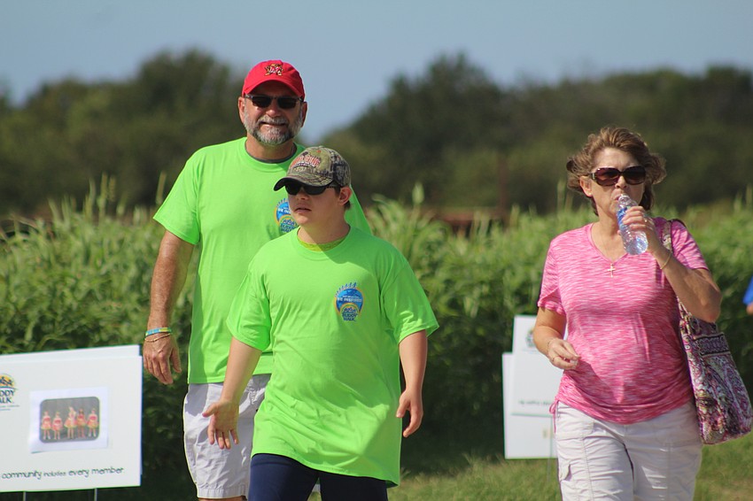 Sarasota's Troy, Sam and Lisa Brode try to keep cool during their walk for Down syndrome awareness.