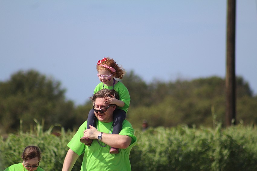 Lakewood Ranch's Emma and Richard Barry try to keep their glasses in tact during the 15th annual Buddy Walk.