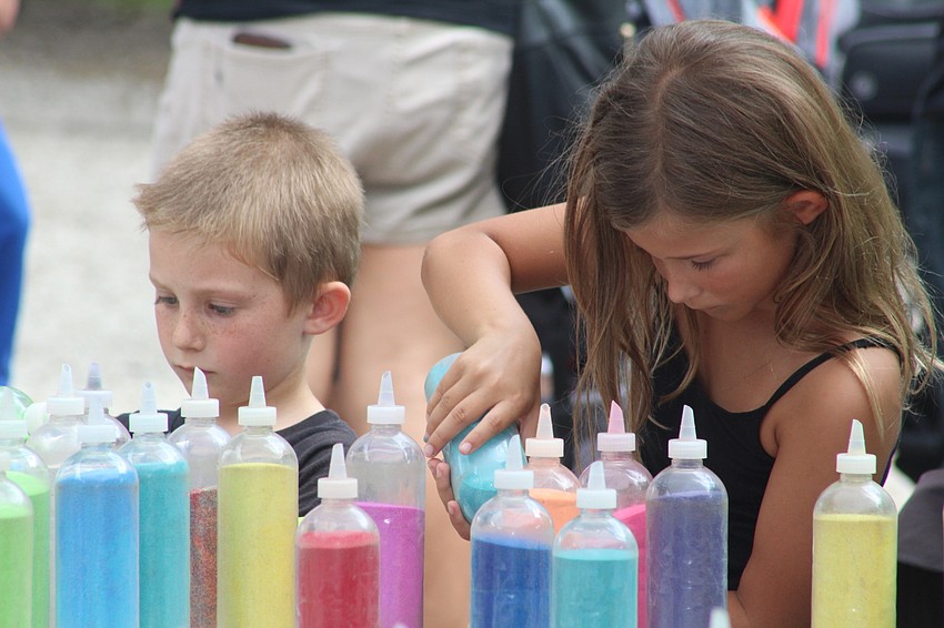 Sarasota's Archer and Ainsley Blank get creative at the sand art booth.