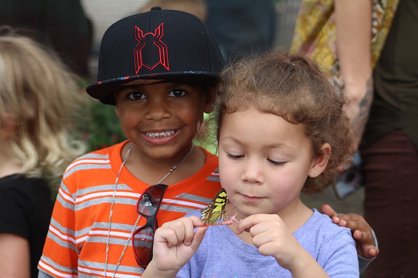Bradenton's Aiden Kit and Sophie Bonet check out the butterfly garden.