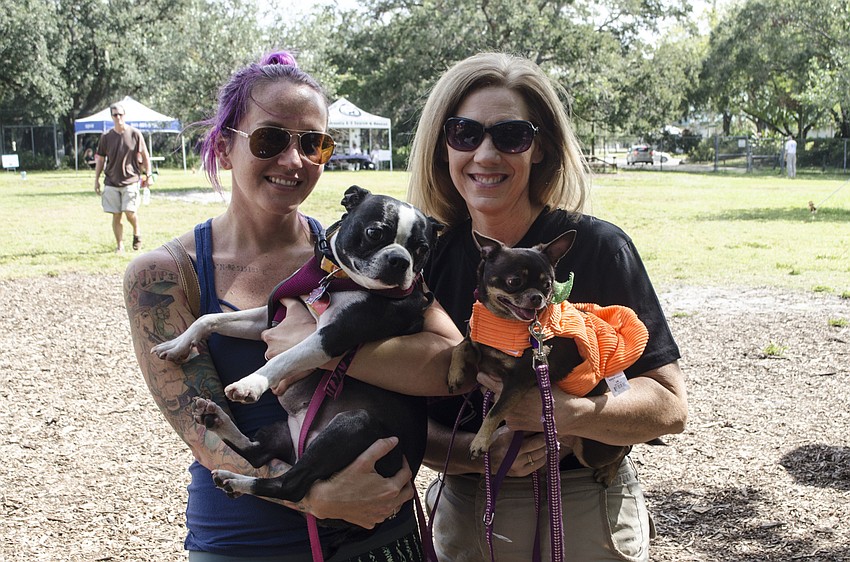 Cody Jeffers and her dog Penny, left, and Darlene Antinori and Reesie.