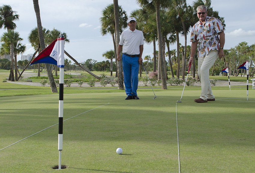 Police Chief Pete Cumming (right) raised $1,100 for Longboat Key's emergency services Saturday, sinking his first two putts in two shots and his last in three.