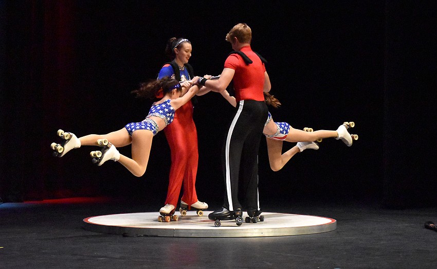 Sailor Circus members perform an acrobatic roller skating act.
