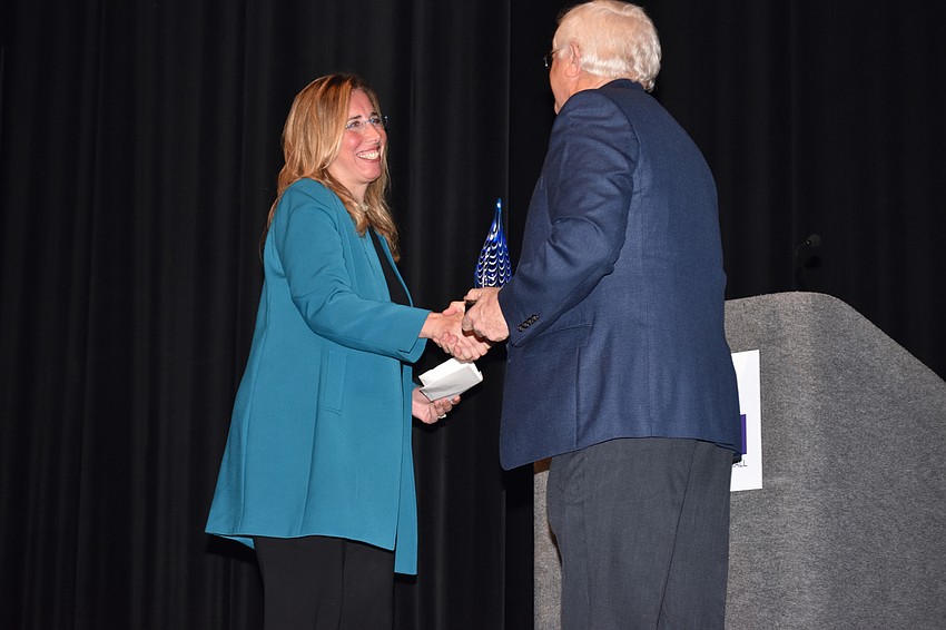 Jennifer Rominiecki accepts the Arts Leadership Award for Arts Management from Jim Shirley.