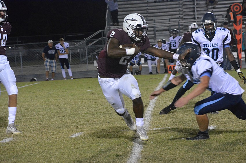 Braden River running back Deshaun Fenwick stiff arms a North Port defender. The senior ran for 220 yards in the win.