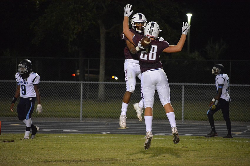 Braden River senior Craivon Koonce bumps chests with sophomore Travis Tobey after Koonce ran for a first-half touchdown.