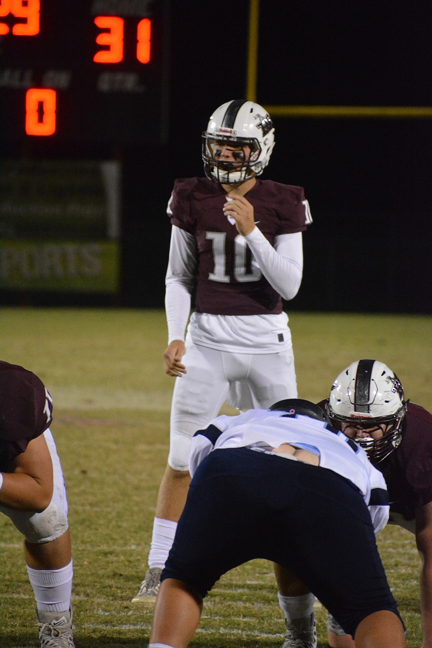 Braden River junior quarterback Bryan Gagg surveys the North Port defense in the second quarter. He threw for 200 yards on the night.