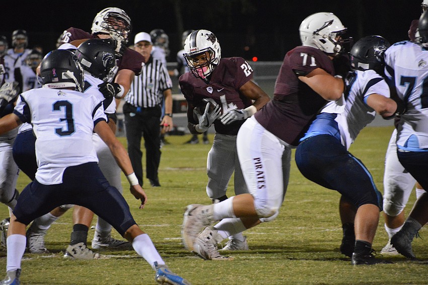 Braden River junior Camaron White bursts through a hole in the offensive line.
